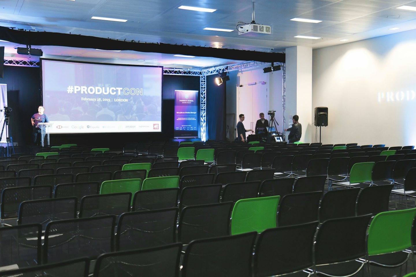 Empty conference hall with stage and projection screen before event.